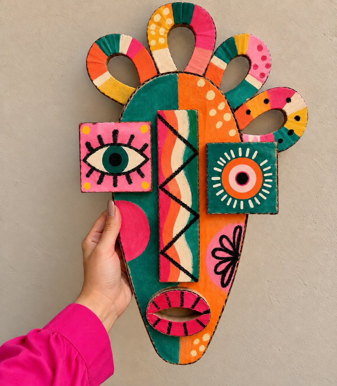 Handcrafted folk art mask with geometric painted details